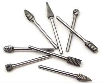 Carbide burrs with machine ground cutting flutes