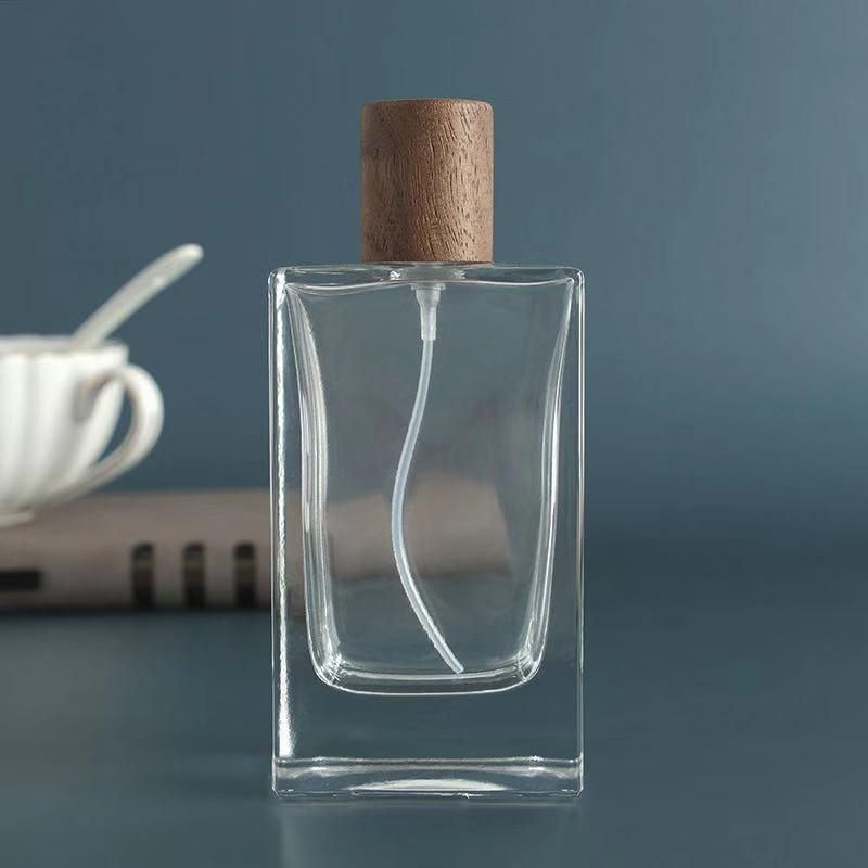 Custom Engraved Logo Crimping Neck 100ml Glass Spray Perfume Bottle with Wooden Lids