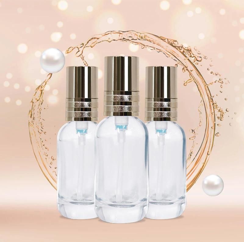 30ml China Supplier Luxury Cosmetic Packaging Round Glass Bottle with Golden Effect Pump Head