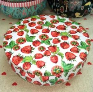 a Tin Box with a Strawberry Design