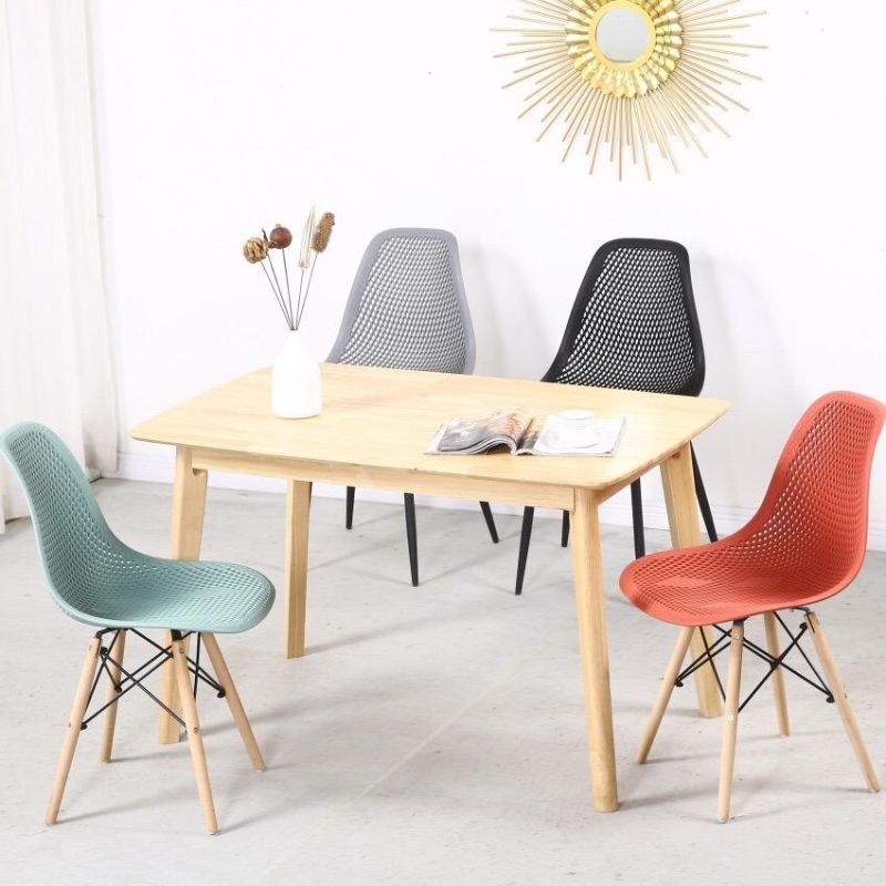 China Cheap Colored Hot Selling Plastic Emes Chairs with Wooden Legs Sillas Comedor